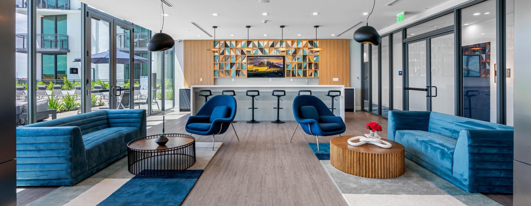 a room with blue couches and a table