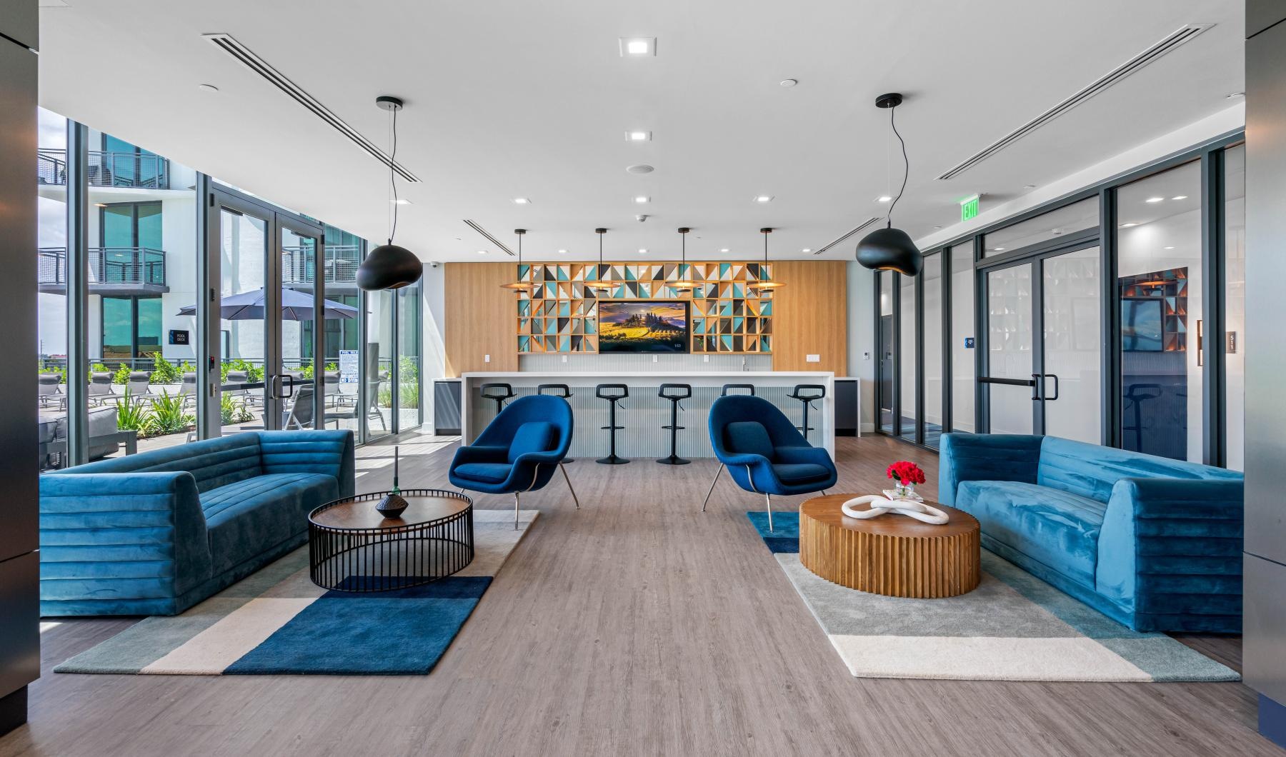 a room with blue couches and a table